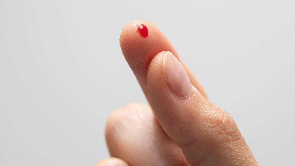Hypoglycemia prevention as a diabetic person is seen closeup with pierced finger, small drop of blood on fingertip to monitor and analyze sugar levels in the body., Hypoglycemia prevention as a diabetic person is seen closeup wit