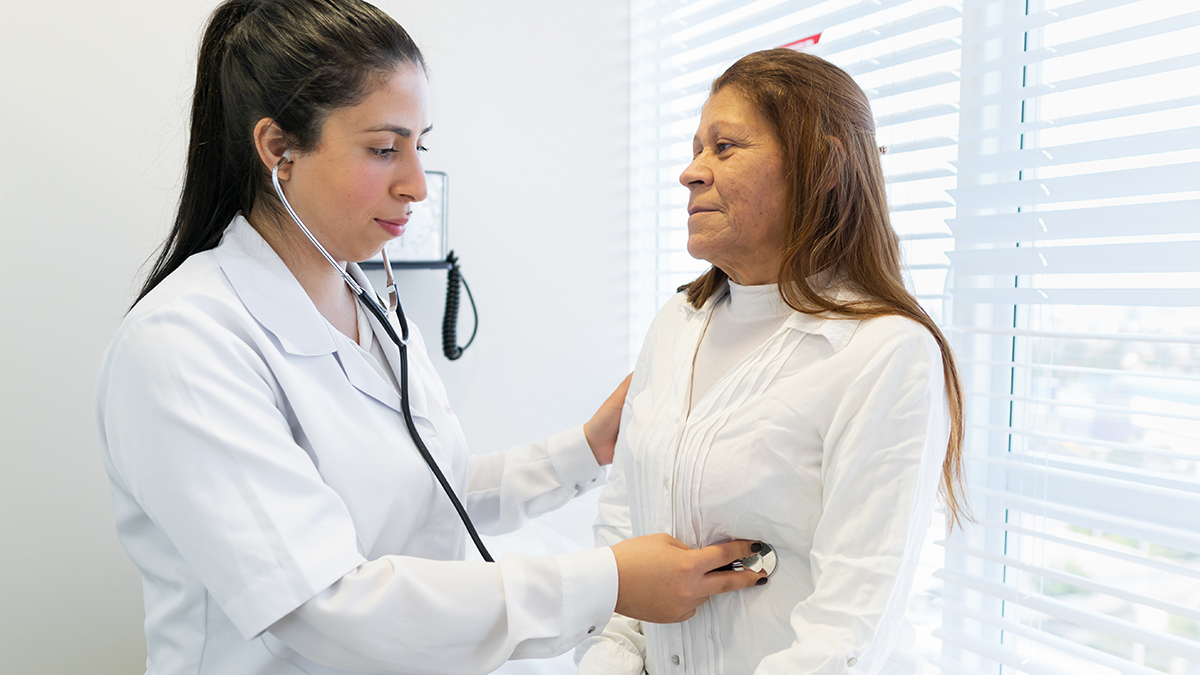 Friendly brazilian female physician with stethoscope examing patient in doctors office health, medical, medicine concept.
, Friendly brazilian female physician with stethoscope examing pat